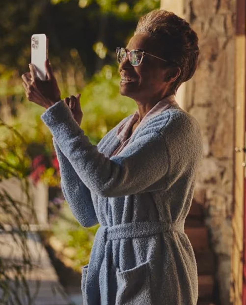 Woman in gray robe smiling